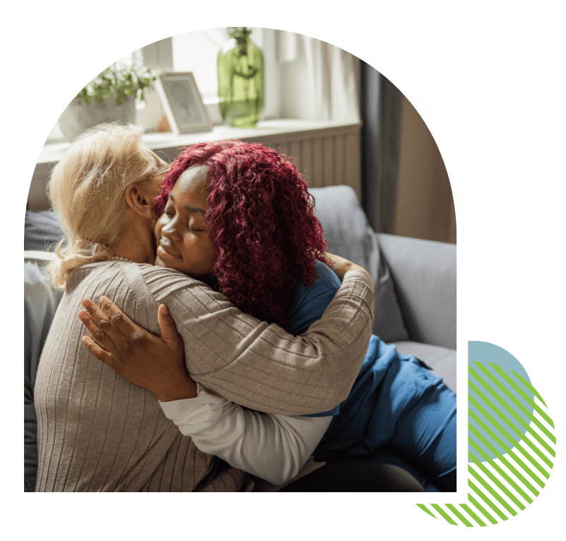 Companion caregiver hugging and comforting a senior woman at home in Putnam County, FL