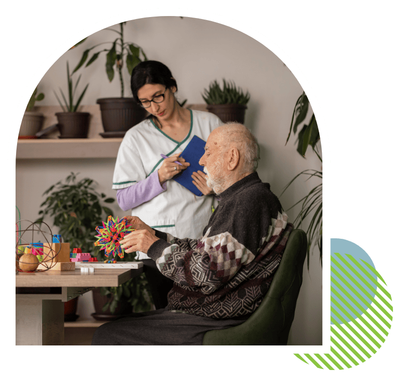 Caregiver assisting a senior man during Alzheimer’s and dementia care services in Putnam County, FL